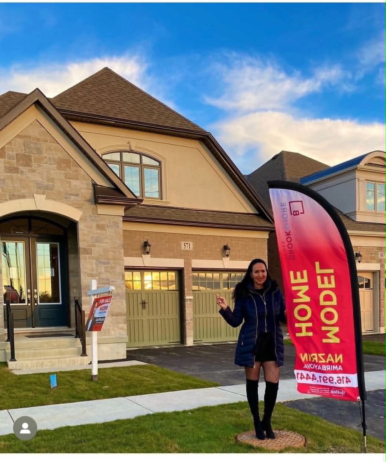 Nazrin beside a model home banner at a new build community